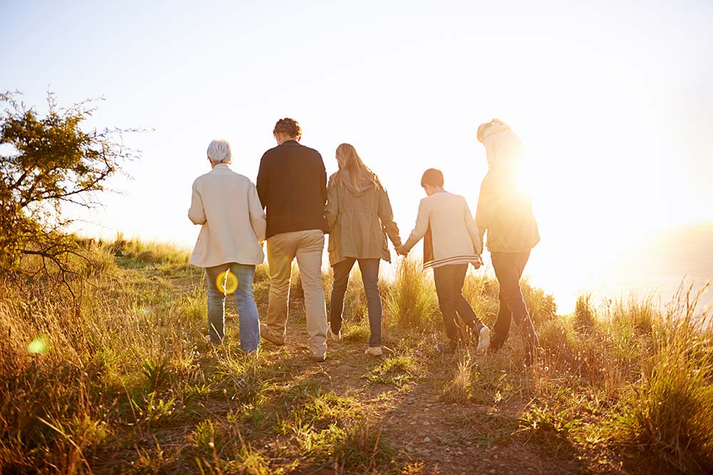 family walking together at sunset